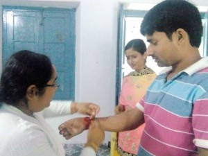 B.K. Preeti tying Rakhi to Civil Judge Dev Kumar Pathak